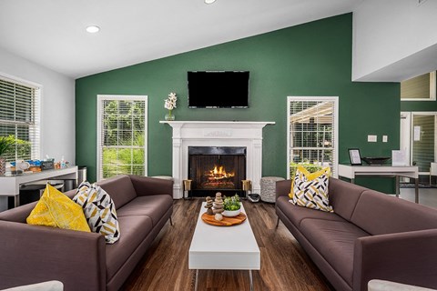 a living room with two brown couches and a fireplace